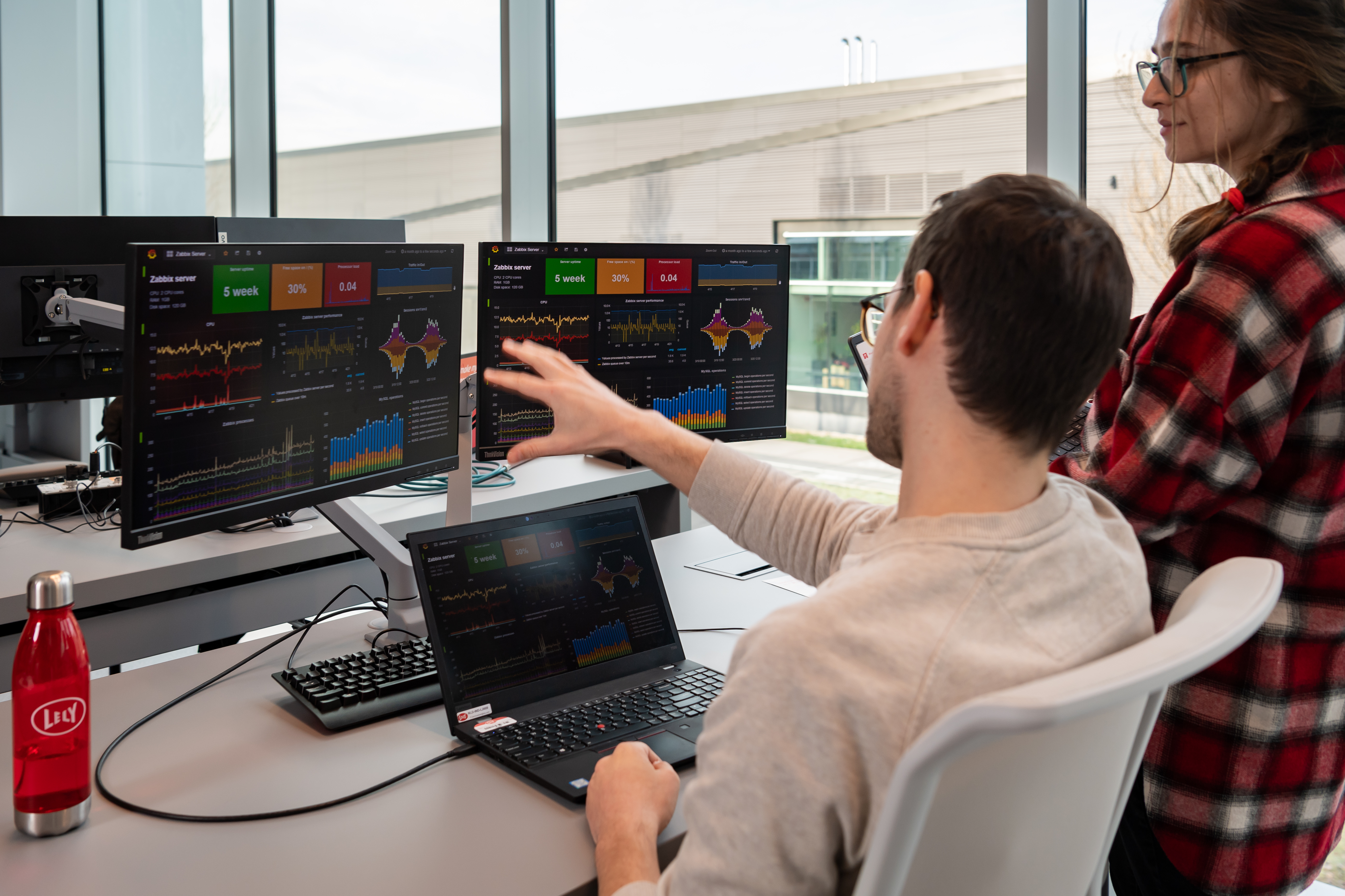 IT colleagues behind computer